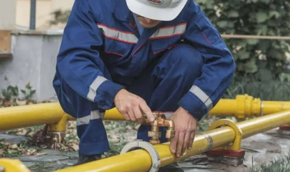 Plumber with tools doing reparation in the kitchen.